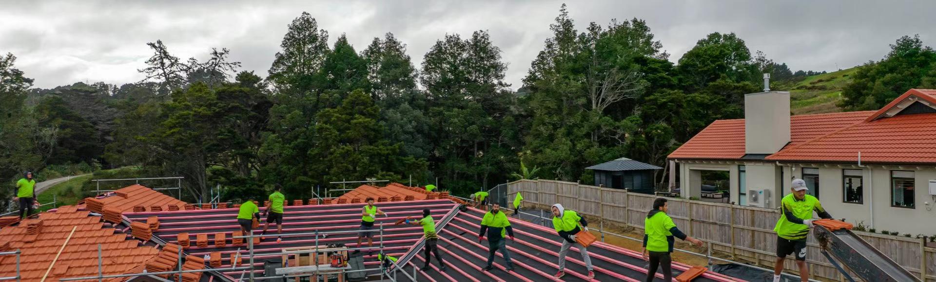 Excel Roofing team installing roof tiles together